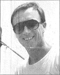 Head and shoulders image of Desmond Boomer, in t-shirt and wearing sun glasses