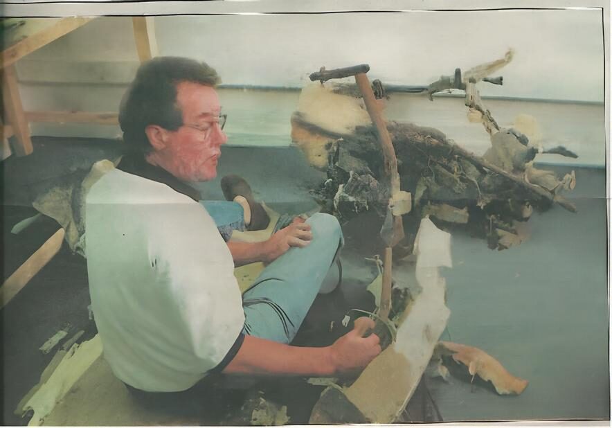 Paul Lehman, crash investigator, demonstrates where the pilot would sit